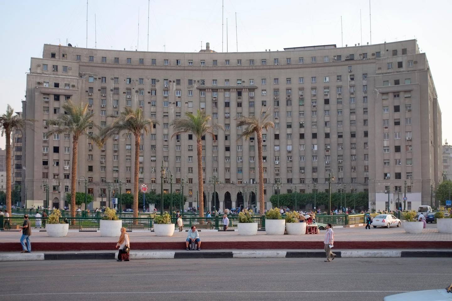 The Mogamma Building is a government building in Cairo, Egypt.  Mugamma is an administrative government building, where all the paper work is done by government agencies.  Tahrir Square may have become the center of the uprising in Egypt due to its poor planning.  Dr Rabbat said 22 streets connect to the plaza, which he calls space 