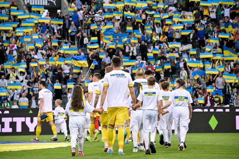 Players walk onto the pitch before a benefit football match between Borussia Moenchengladbach and the national team of Ukraine at Borussia-Park in Moenchengladbach, Germany. EPA