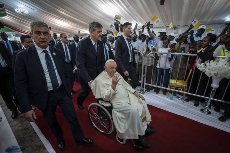 Pope Francis waves as he leaves a meeting with internally displaced people at Freedom Hall. AP