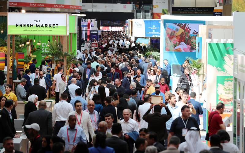 Customers browsing the various food stands at Gulfood