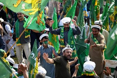 Supporters of Pakistan's former prime minister Nawaz Sharif wave party's flags as they await his arrival at a park in Lahore on Saturday. AFP