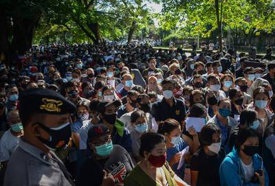 People queue to register for the AstraZeneca Covid-19 coronavirus vaccine in Denpasar, on Indonesia's resort island of Bali. AFP