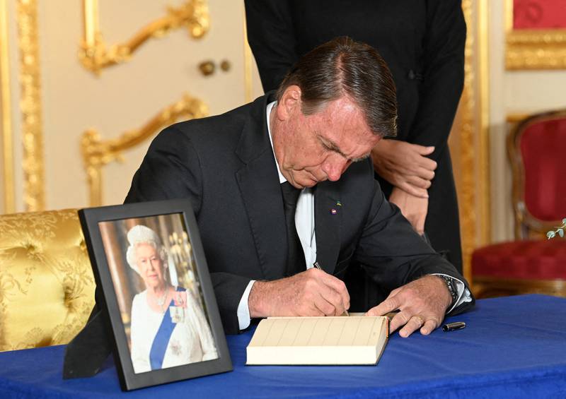 Brazilian President Jair Bolsonaro signs a book of condolence at Lancaster House in London, after the death of Queen Elizabeth II.  Reuters