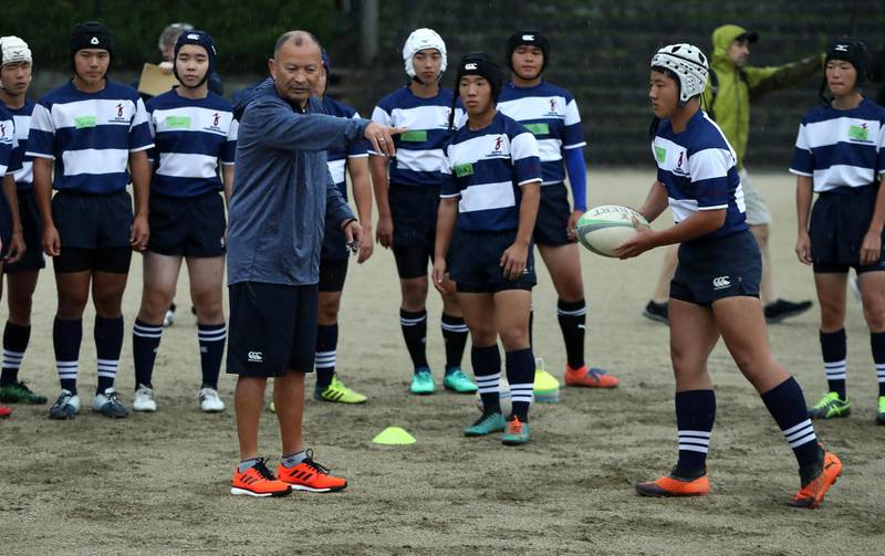 England head coach Eddie Jones with students at Tsurumigaoka High School in Beppu on Thursday . Getty