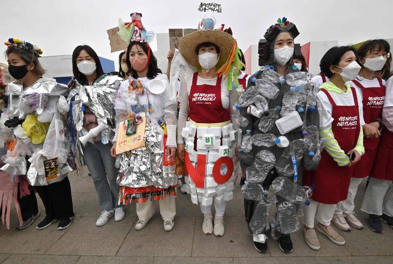 South Korean environmental activists wear outfits made of plastic waste during a campaign against climate change at a park along the Han River in Seoul. AFP