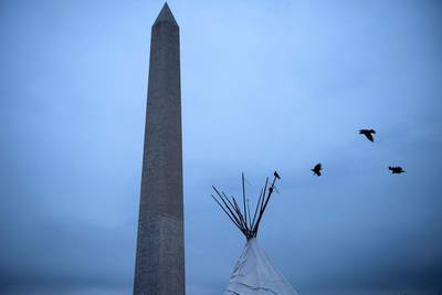 Birds land on a tepee at a Native American camp during the Native Nations Rise protest on the National Mall near the Washington Monument in Washington, DC. Brendan Smialowski / AFP / March 10, 2017