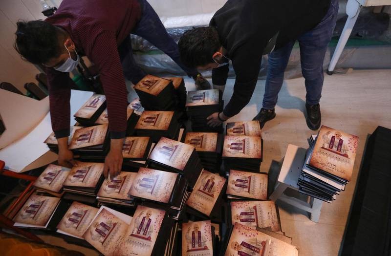 Workers print flyers of Pope Francis at a shop in Erbil, the capital of Iraq's northern autonomous Kurdish region, ahead of the first-ever papal visit to Iraq. AFP