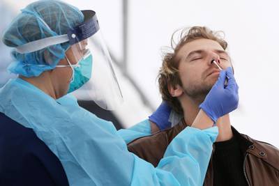 Registered Nurse Michelle Gibbons conducts a Covid-19 swab test on a man at Bondi Beach in Sydney, Australia. Getty Images