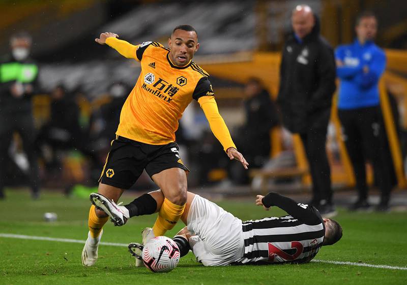 WOLVERHAMPTON, ENGLAND - OCTOBER 25: Fernando Marcal of Wolverhampton Wanderers is challenged by Ryan Fraser of Newcastle United during the Premier League match between Wolverhampton Wanderers and Newcastle United at Molineux on October 25, 2020 in Wolverhampton, England. Sporting stadiums around the UK remain under strict restrictions due to the Coronavirus Pandemic as Government social distancing laws prohibit fans inside venues resulting in games being played behind closed doors. (Photo by Stu Forster/Getty Images)