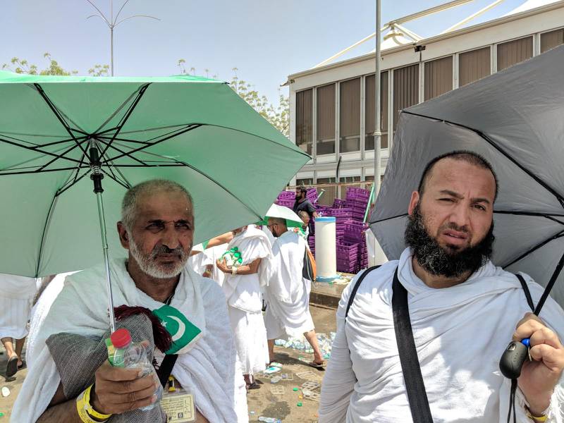 Imrad Mohammed, right, and his father, left, will persist with the Hajj despite the heat