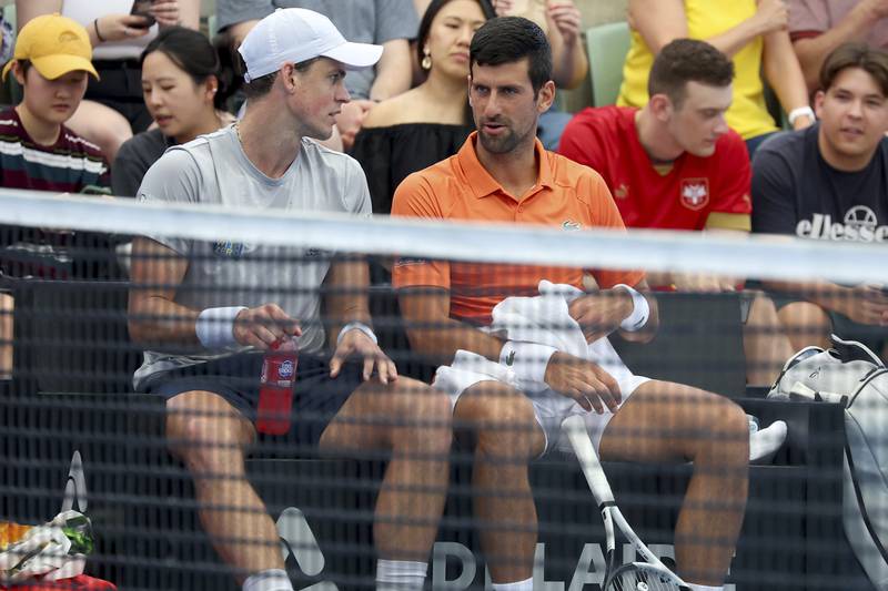 Canada's Vasek Pospisil and Serbia's Novak Djokovic talk tactics. AP Photo