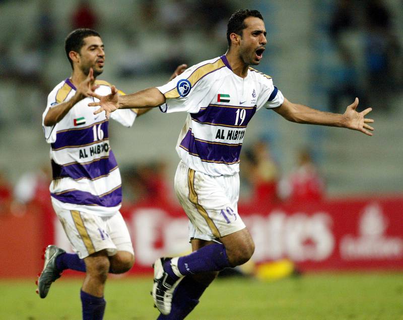 Fahad Ali Musabah (#19) and Abdulla Ali Musabbeh of Al Ain celebrate after the final whistle during the second leg of the AFC Champions League Final between Al Ain of UAE and Bec Tero Sasana of Thailand held at the Rajamangala National Stadium Bangkok, 11 October 2003. AFP PHOTO/Stanley Chou/WSG (Photo by STANLEY CHOU / WSG / AFP)