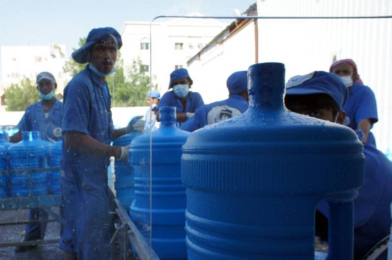 Saudi workers load carboys of "zamzam" water containers at the Zamazemah United Office in Mecca, on November 7, 2010. According to Islamic belief, zamzam is a miraculously-generated source of water from God, which began thousands of years ago when Abraham's infant son Ishmael was thirsty and crying for water when it discovered a well by kicking the ground. Millions of pilgrims visit the well each year while performing the Hajj or Umrah pilgrimages, in order to drink its water.  AFP PHOTO / MUSTAFA OZER (Photo by MUSTAFA OZER / AFP)