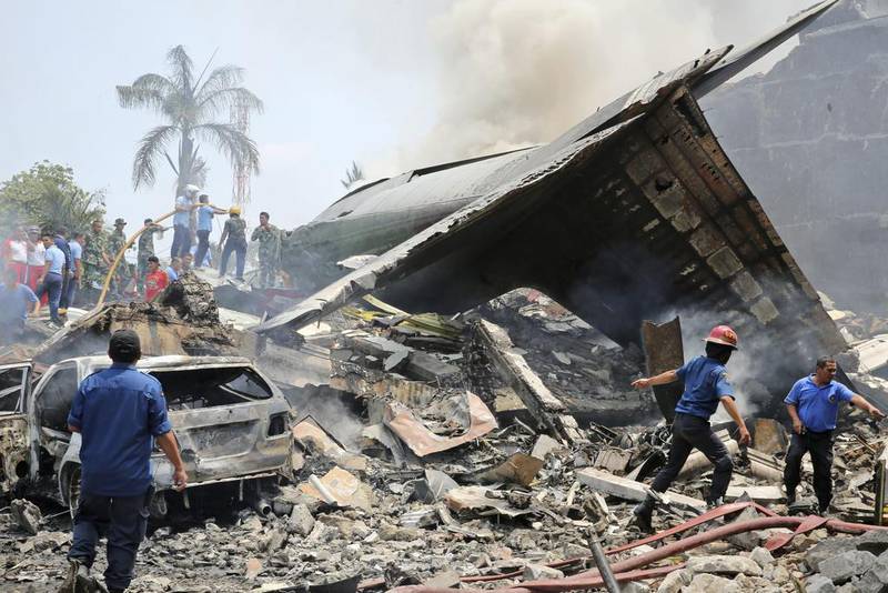 Rescuers search for victims at the crash site of an air force cargo plane in Medan, North Sumatra, Indonesia. Associated Press / Hafiz
