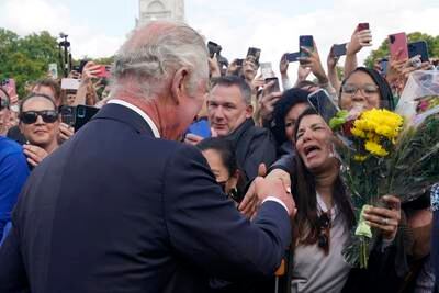 King Charles greets well-wishers outside Buckingham Palace. AP