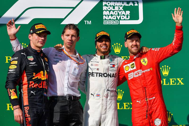 Sebastian Vettel, right, on the podium with Max Verstappen, left, and Lewis Hamilton, centre, after the Hungarian Grand Prix. EPA