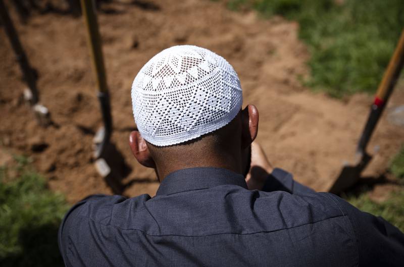 Muslim men pray over the grave of Muhammad Afzaal Hussain. The Albuquerque Journal / AP