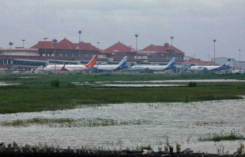 Airplanes are pictured as they are parked next to flood waters on the tarmac of the international airport in Kochi in southern Kerala state on August 9, 2019. Floods that have killed more than 20 people forced the closure of Kochi international airport on August 9 as the south Indian state of Kerala confronted a second straight year of crisis level downpours.
 / AFP / STR
