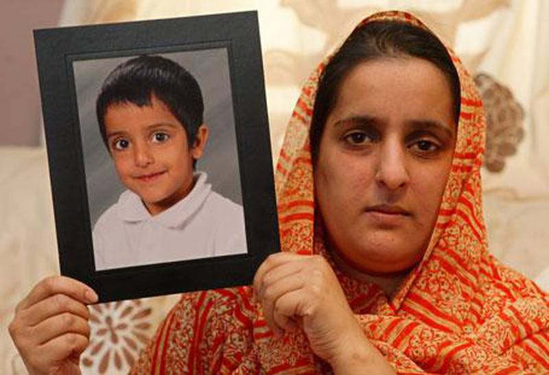 Akila Naqqash holds a photo of her five-year-old son Sahil Saeed, in Oldham, Manchester.