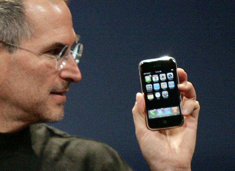 Apple co-founder Steve Jobs holds the latest iPhone in San Francisco on January 9, 2007. These days, the device's steps forward are incremental at best – a better processor, better battery life, or a better camera. Reuters