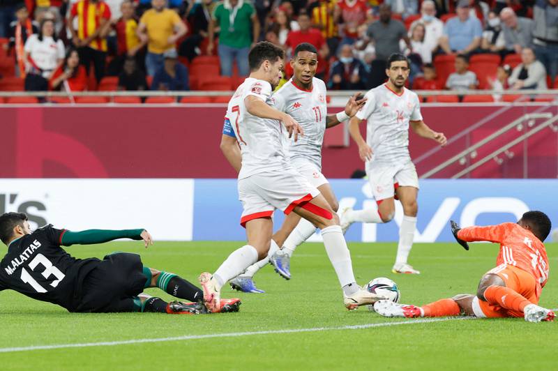 UAE goalkeeper Khalid Eisa attemtps to save at feet of Tunisia's Youssef Msakni. AFP