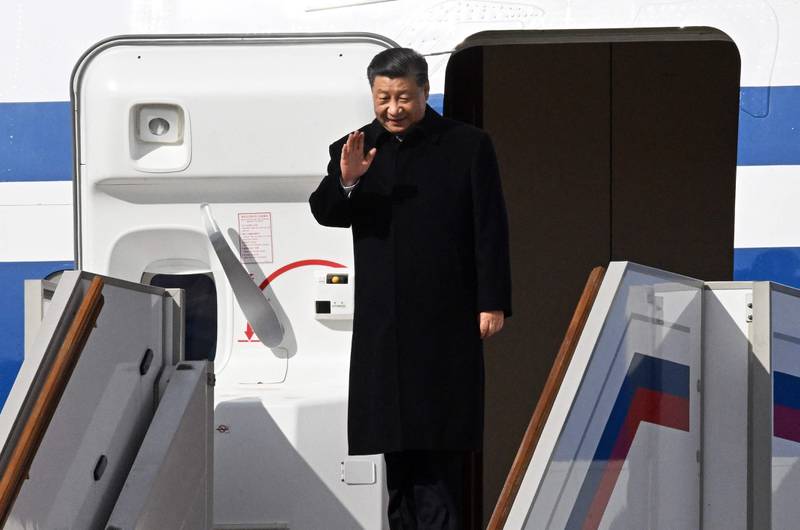Mr Xi arrives at Moscow's Vnukovo Airport. AFP