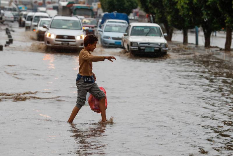A Yemeni boy walks through a flooded street following heavy rains in Sana'a, Yemen.  EPA