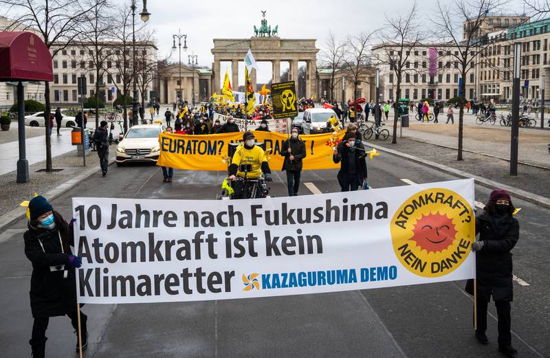 Anti-nuclear protesters in Berlin, Germany, with a banner reading '10 years after Fukushima nuclear power is not a climate saviour'. Getty