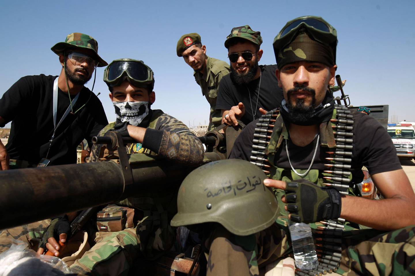 Members of the self-proclaimed eastern Libyan National Army (LNA) special forces gather in the city of Benghazi, on their way to reportedly back up fellow LNA fighters on the frontline west of the city of Sirte, facing forces loyal to the UN-recognised Government of National Accord (GNA), on June 18, 2020.  The resurgent GNA has vowed to push on for Sirte, late Libyan leader Moamer Kadhafi's hometown and the last major settlement before the traditional boundary between western Libya and Haftar's stronghold in the east. / AFP / Abdullah DOMA
