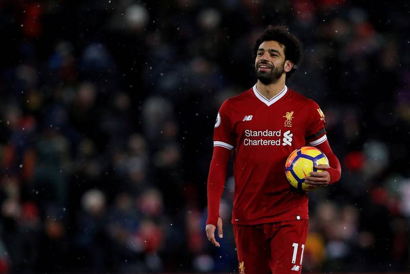 Liverpool's Mohamed Salah celebrates with the match ball after scoring four goals against Watford at Anfield on March 17, 2018. Action Images via Reuters / Lee Smith