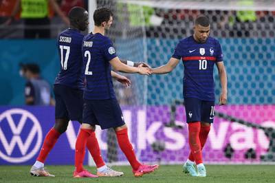 Mbappe is consoled by teammates after missing the penalty. AFP