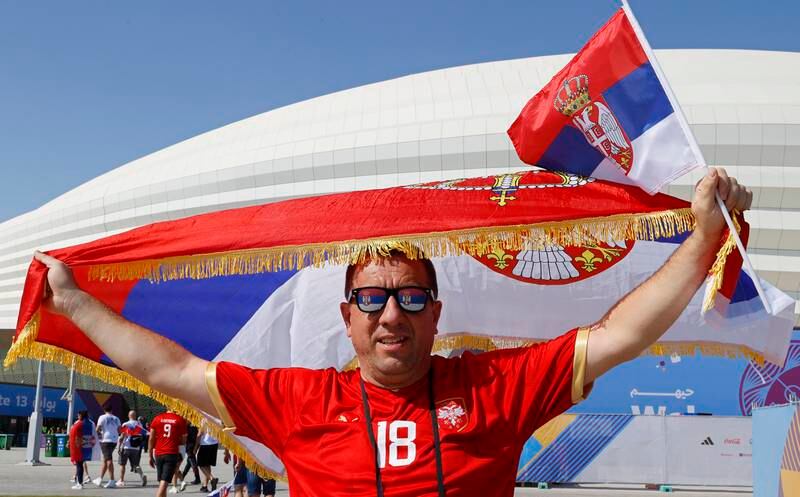 A Serbia fan cheers outside the stadium in Al Wakrah. EPA