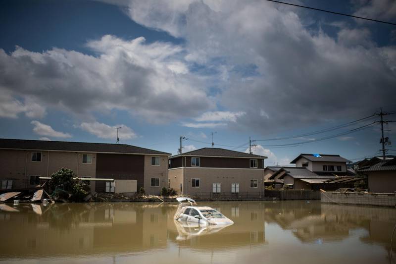 A car sits in water after the area was devastated by flooding and landslides in Mabi, Okayama. AFP