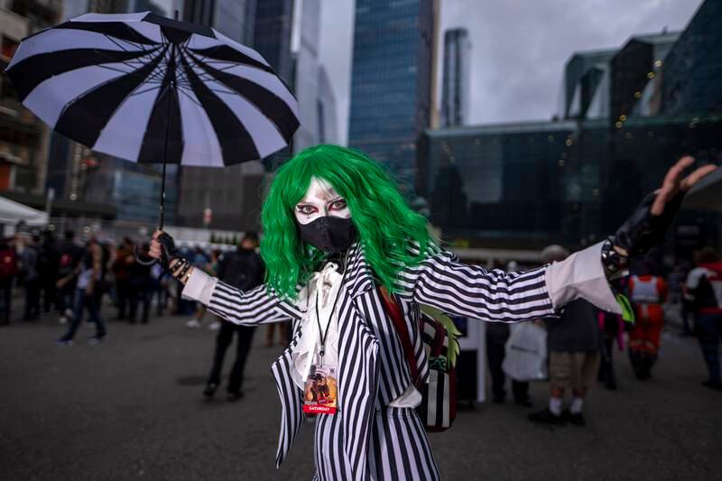 An attendee dressed as Beetlejuice poses during New York Comic Con. Charles Sykes / Invision / AP