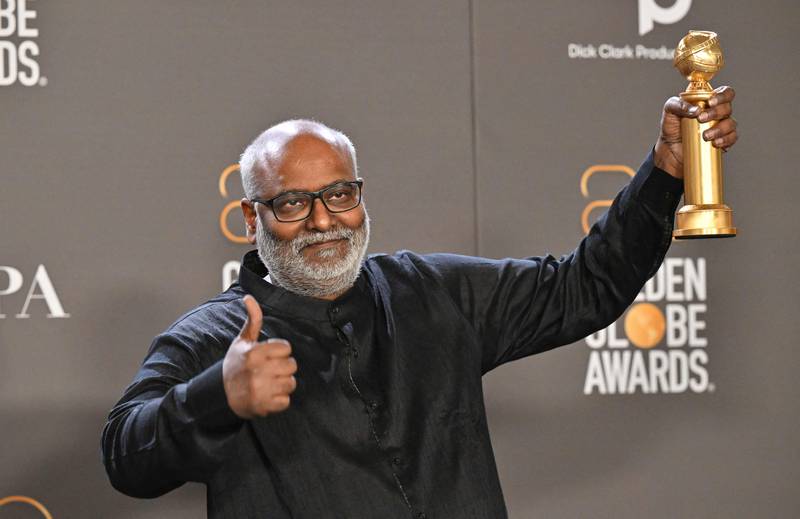 Indian film composer M M  Keeravani with the award for Best Song - Motion Picture for Naatu Naatu from the film RRR. AFP