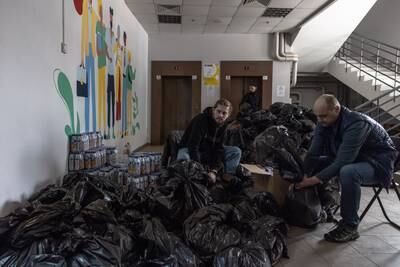 Volunteers in Kyiv prepare packages with food and other goods for Ukrainian soldiers and civilians in cities across the country. EPA