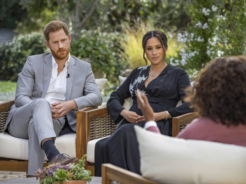 FILE - This image provided by Harpo Productions shows Prince Harry, from left, and Meghan, Duchess of Sussex, during an interview with Oprah Winfrey.  (Joe Pugliese / Harpo Productions via AP, File)