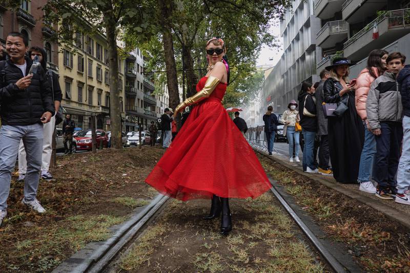 A guest arrives in a striking red outfit. LaPresse via AP