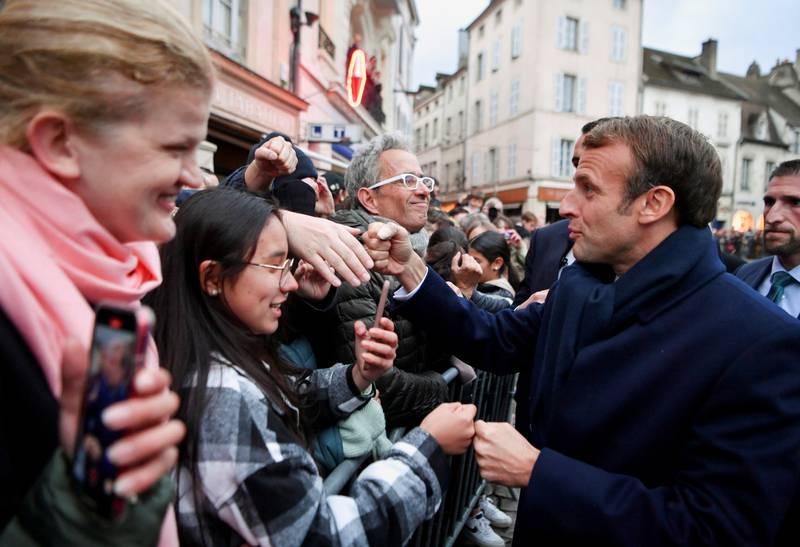Emmanuel Macron speaks to members of the public in Beaune. Reuters