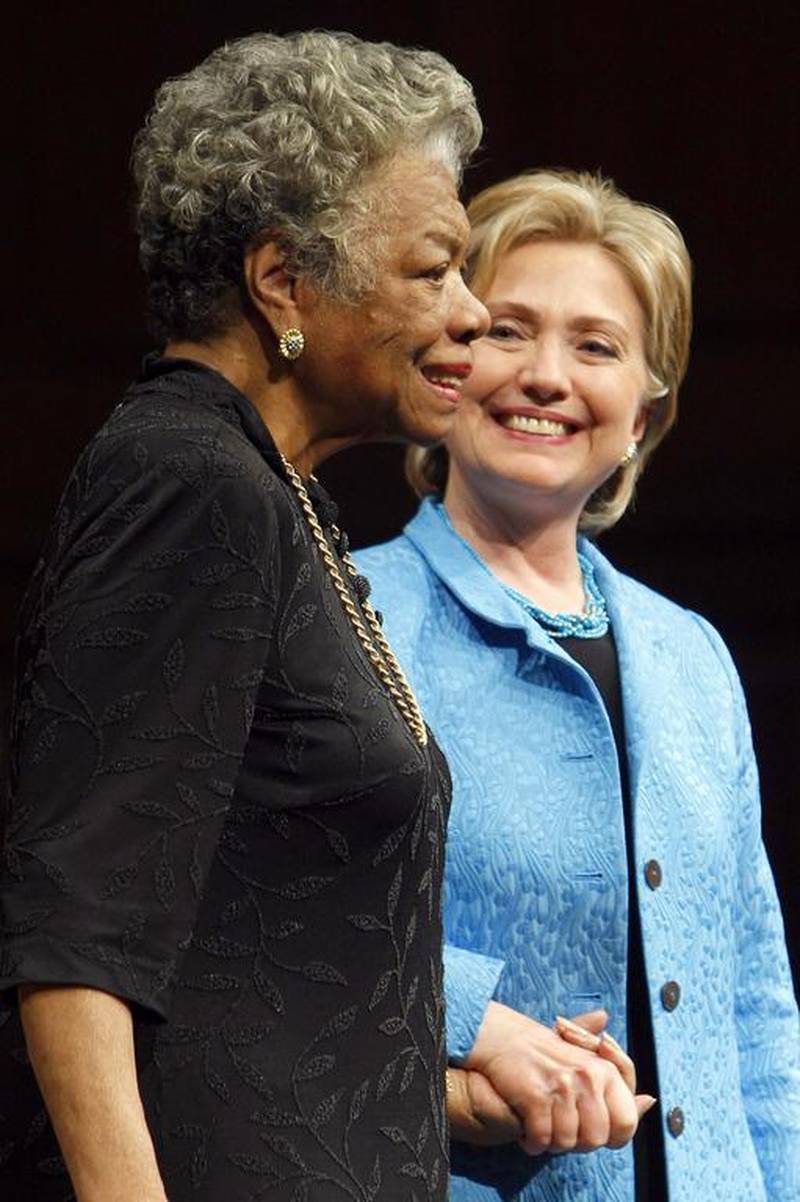 Democratic presidential hopeful Hillary Rodham Clinton, right, holds the hand of Dr Maya Angelou during a conversation in front of an audience at Wake Forest University in Winston-Salem, NC during a campaign stop on April 18, 2008. Robyn Beck / AFP
