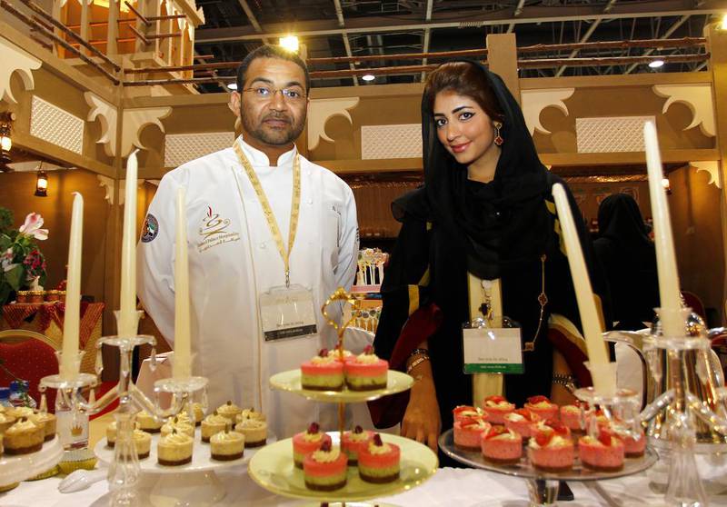 Mariam Karmostaji of Royal Mini Cheesecake with Ali Ebdowa, executive chef at Emirates Palace’s Emirati restaurant, Mezlai, at the Dubai World Hospitality Championship. Jake Badger for The National