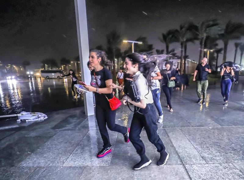 Abu Dhabi, U.A.E., November 12, 2018.  Cancelled concert of Dua Lipa at the Louvre due to a sudden downpour and gusty winds.  Concert goers take refuge at the Louvre Museum area.Victor Besa / The NationalSection:  NAReporter: