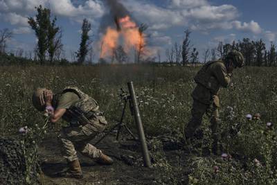Ukrainian soldiers fire a mortar towards Russian positions at the front line, near Bakhmut, Donetsk region, Ukraine. AP photo