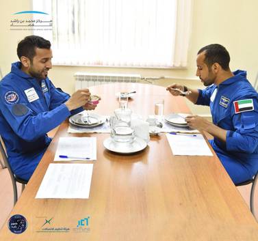 Maj Al Mansouri and his back-up astronaut Sultan Al Neyadi taste Russian-made halal space food at Star City in Russia. Courtesy: MBR Space Centre