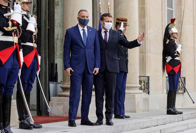 Mustafa Al Kadhimi is welcomed by France's President Emmanuel Macron ahead of a working lunch at the Elysee Palace in Paris. AFP