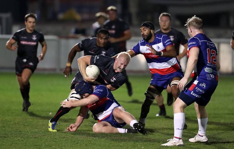  Dubai Exiles' Anthony Kapp is tackled during the match against Jebel Ali Dragons. Pawan Singh / The National   
