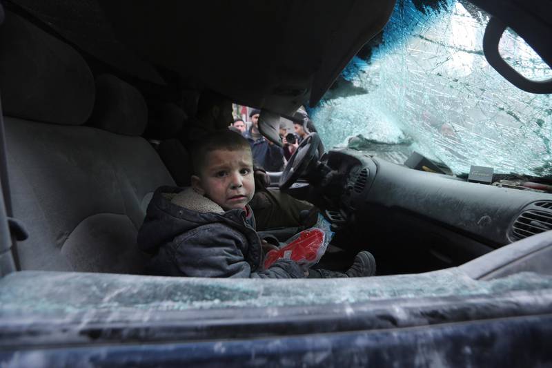 A boy cries in a damaged car after government airstrikes in the town of Ariha, in Idlib province, Syria. AP Photo