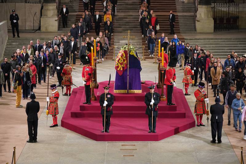 Members of the public pay their respects at 4.57am, shortly before the lying in state ended, as they view the coffin of Queen Elizabeth II in Westminster Hall. AFP