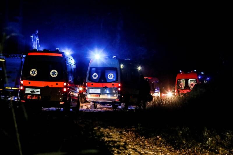 Ambulances are seen at the crash site of the Antonov An-12. Reuters