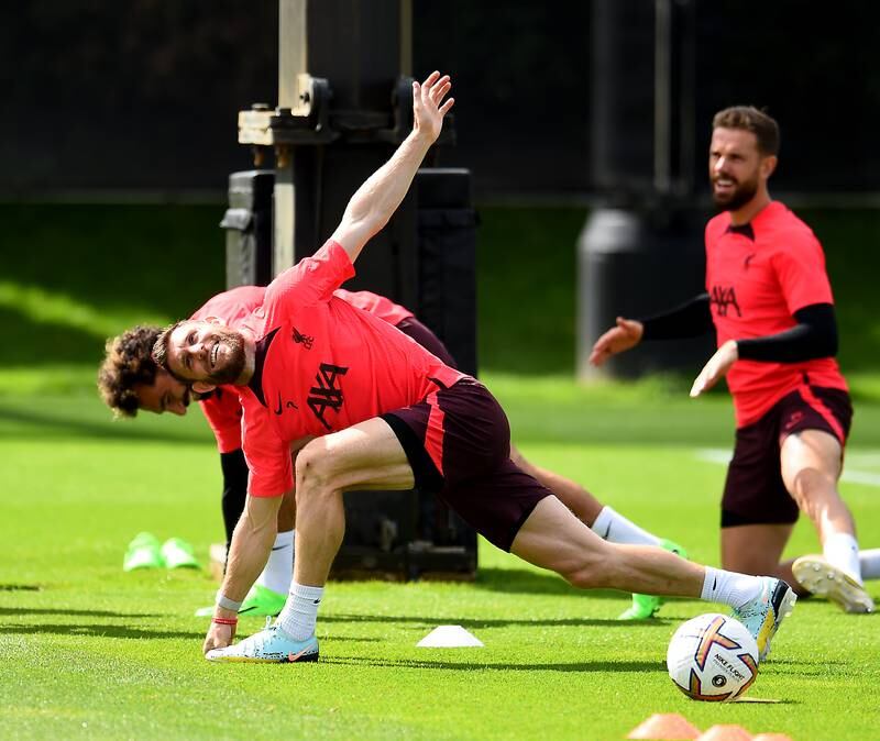 James Milner stretches during Liverpool's training session in Kirkby.